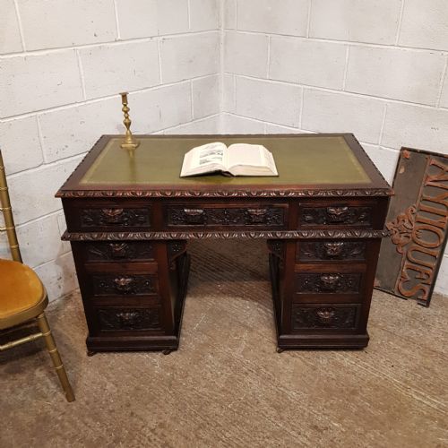 A VICTORIAN GREEN MAN CARVED OAK TWIN PEDESTAL DESK C1880