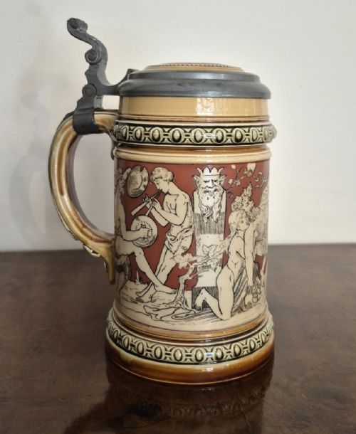 ANTIQUE METTLACH STEIN BY VILLEROY BOCH DECORATED WITH CAROUSING BACCHUS