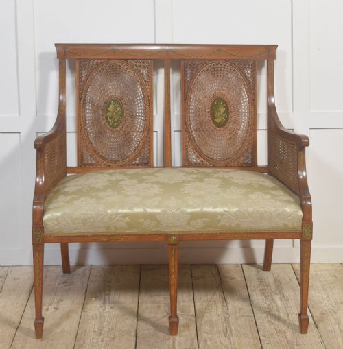 PAINTED SATINWOOD AND CANED SETTEE