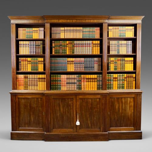 A LATE GEORGE III MAHOGANY BREAKFRONT BOOKCASE